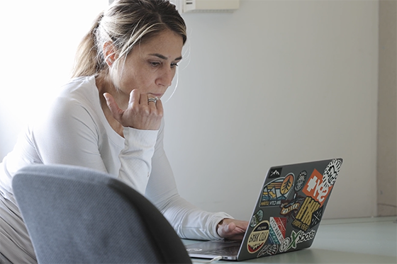 A student works diligently on a laptop in class